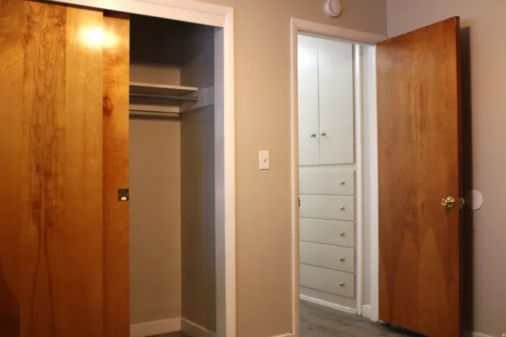 Hallway with wood-finish doors and neutral wall paint