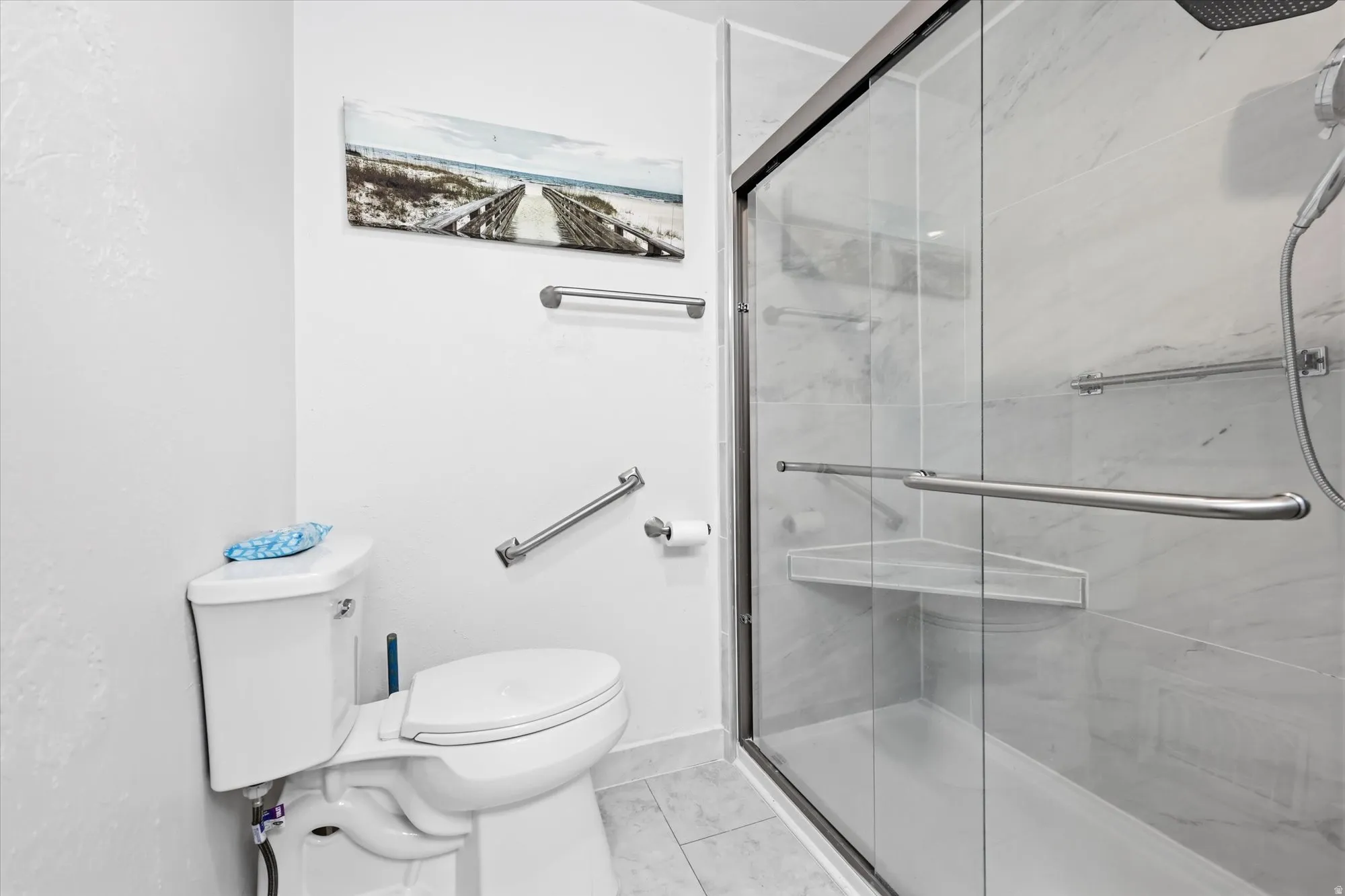 Contemporary bathroom featuring a spacious glass-enclosed shower with a built-in corner shelf and a sliding door