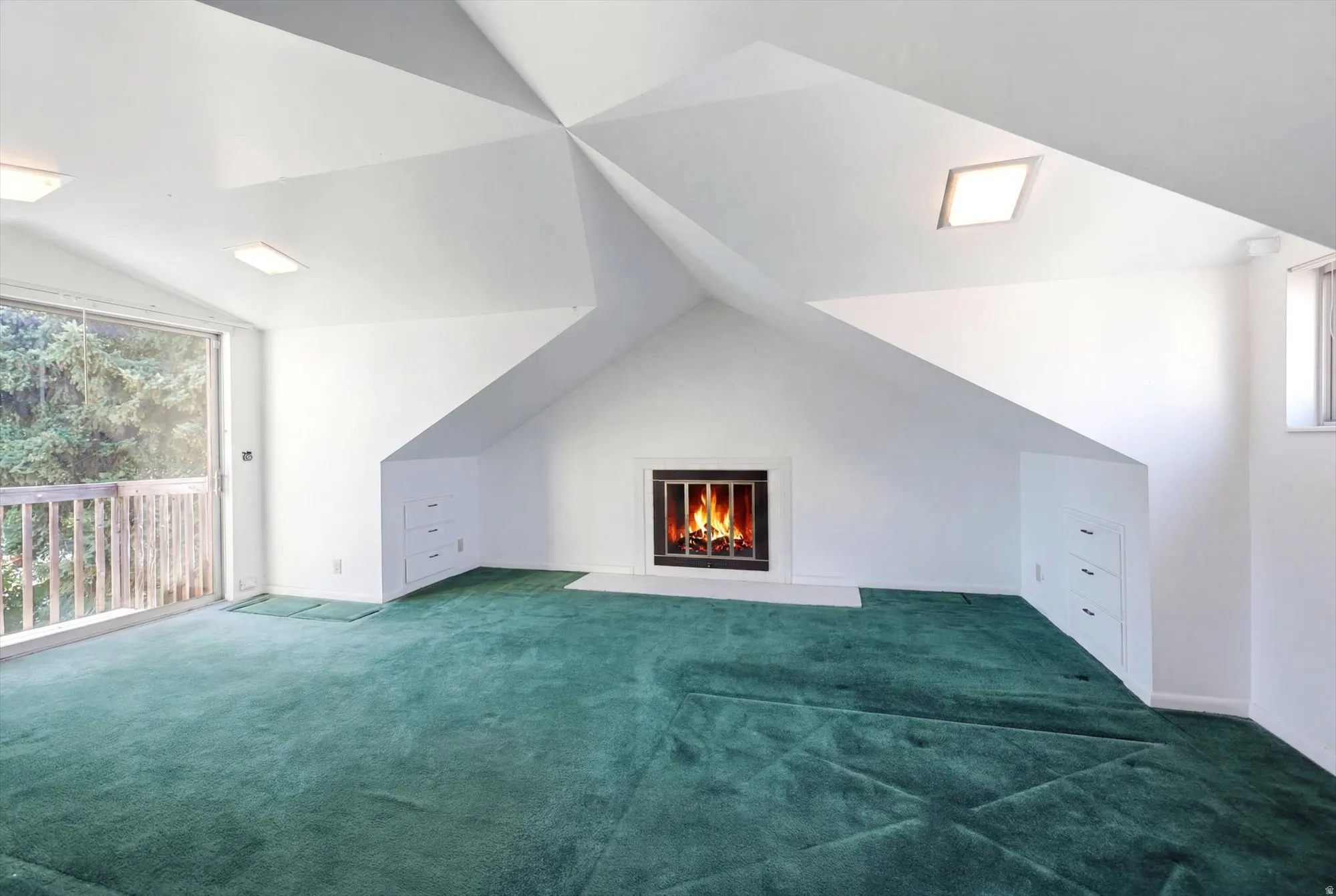 Spacious room featuring a fireplace with a black surround, white mantel, and hearth
