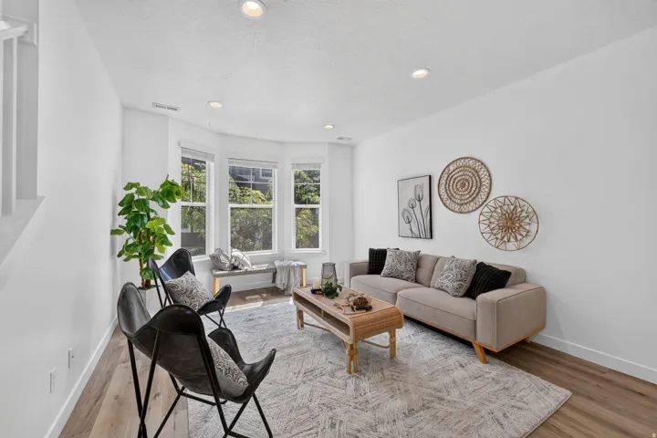 Bright living area featuring wood-finish flooring and recessed lighting