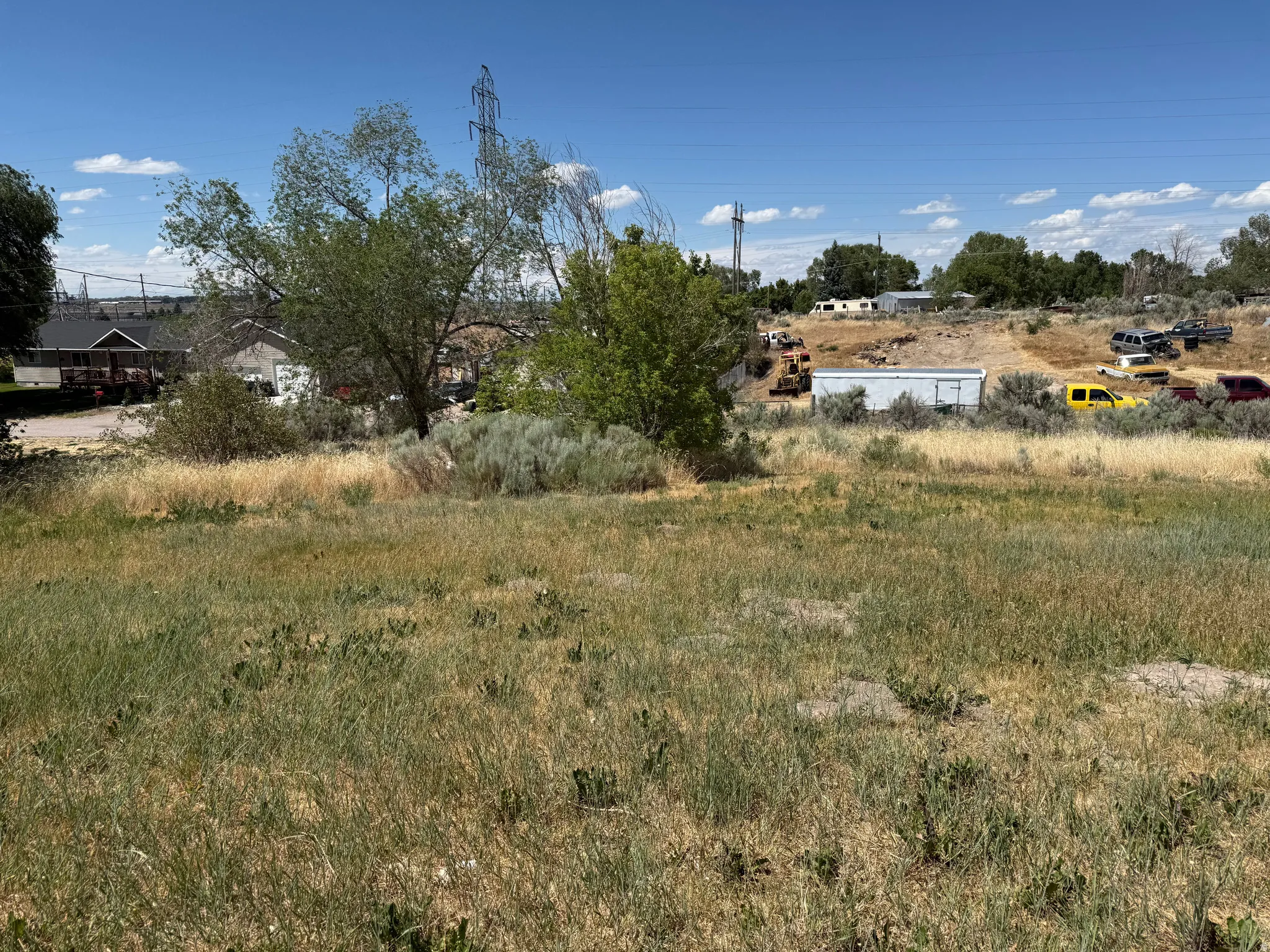 Uncultivated land parcel featuring natural grasses and scattered brush