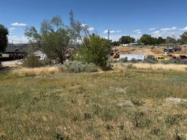 Uncultivated land parcel featuring natural grasses and scattered brush