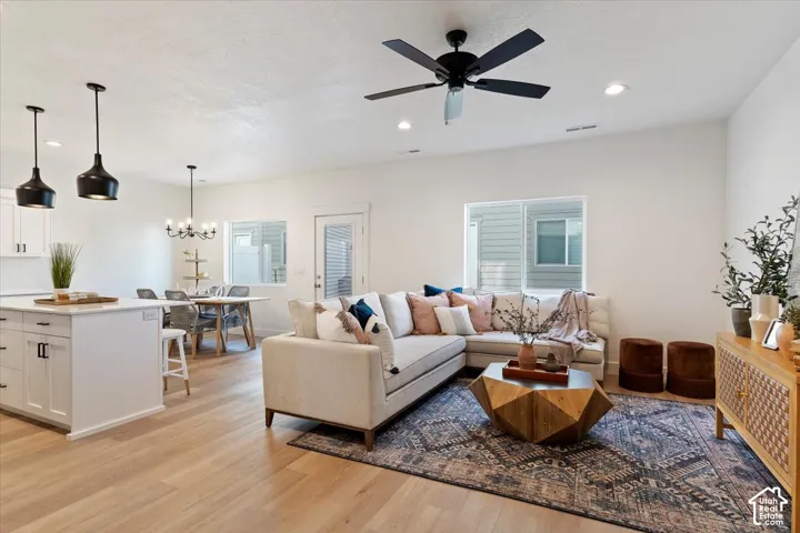 Open-concept living space featuring wood-finish flooring, recessed lighting, and a modern ceiling fan