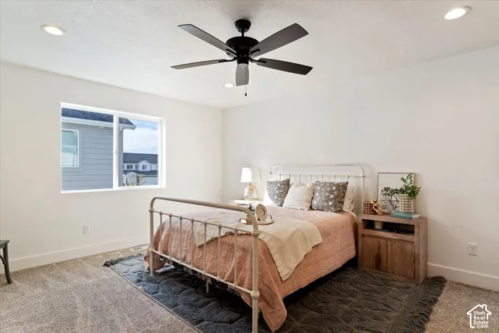 Bedroom featuring a window, recessed lighting, and a ceiling fan