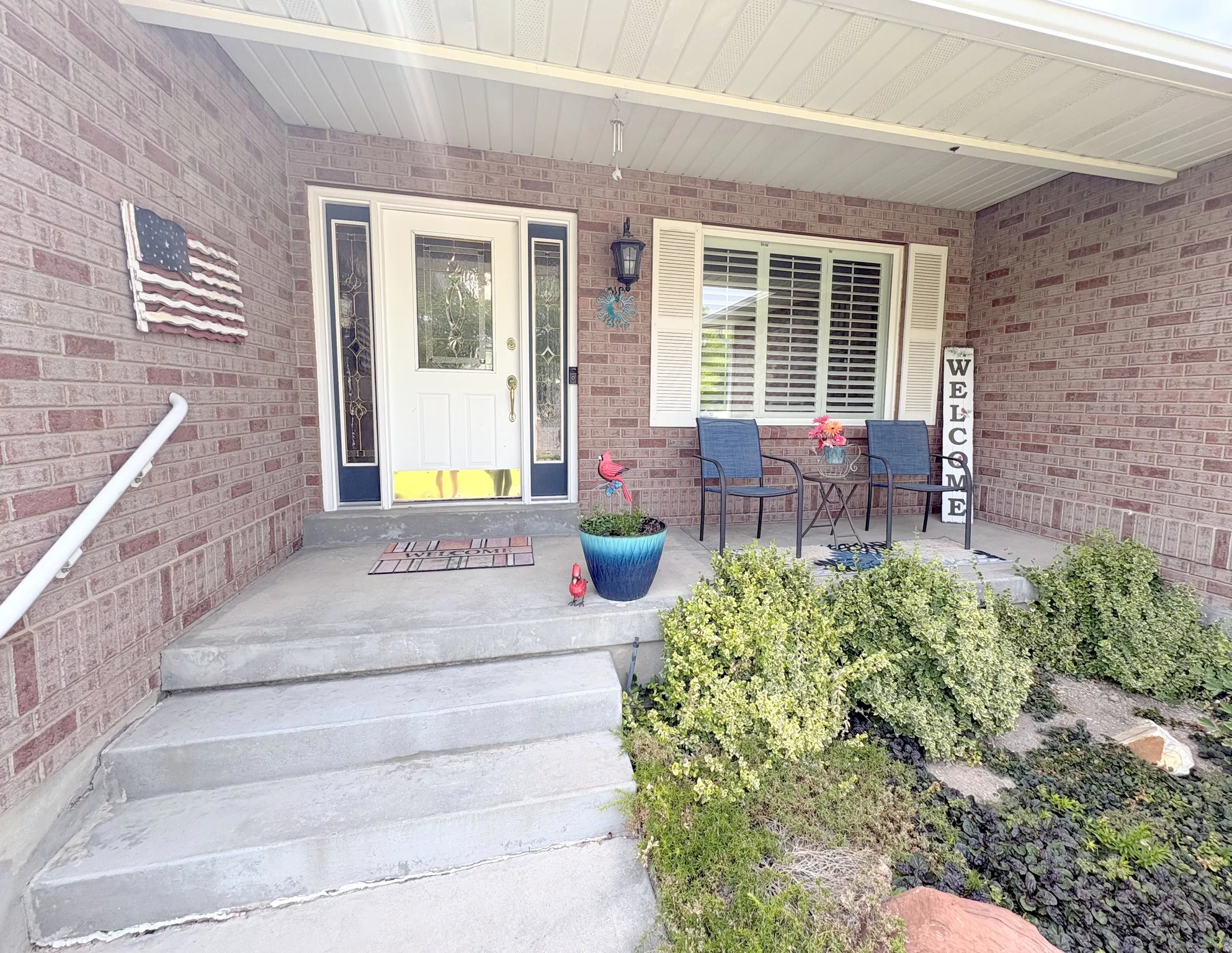 Brick-front exterior featuring a covered porch entry