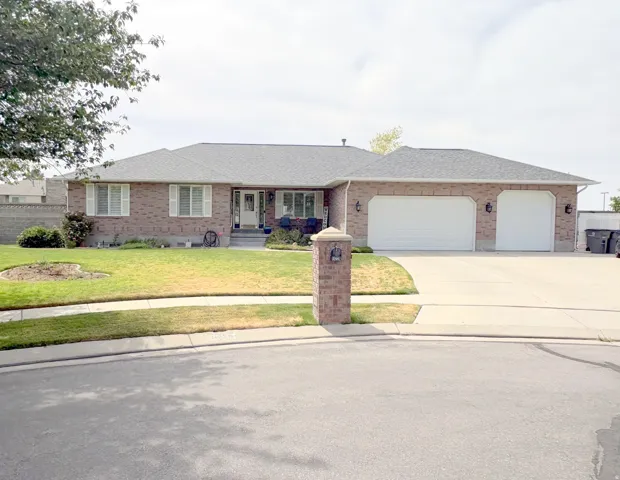 Brick exterior residence with a gray shingle roof