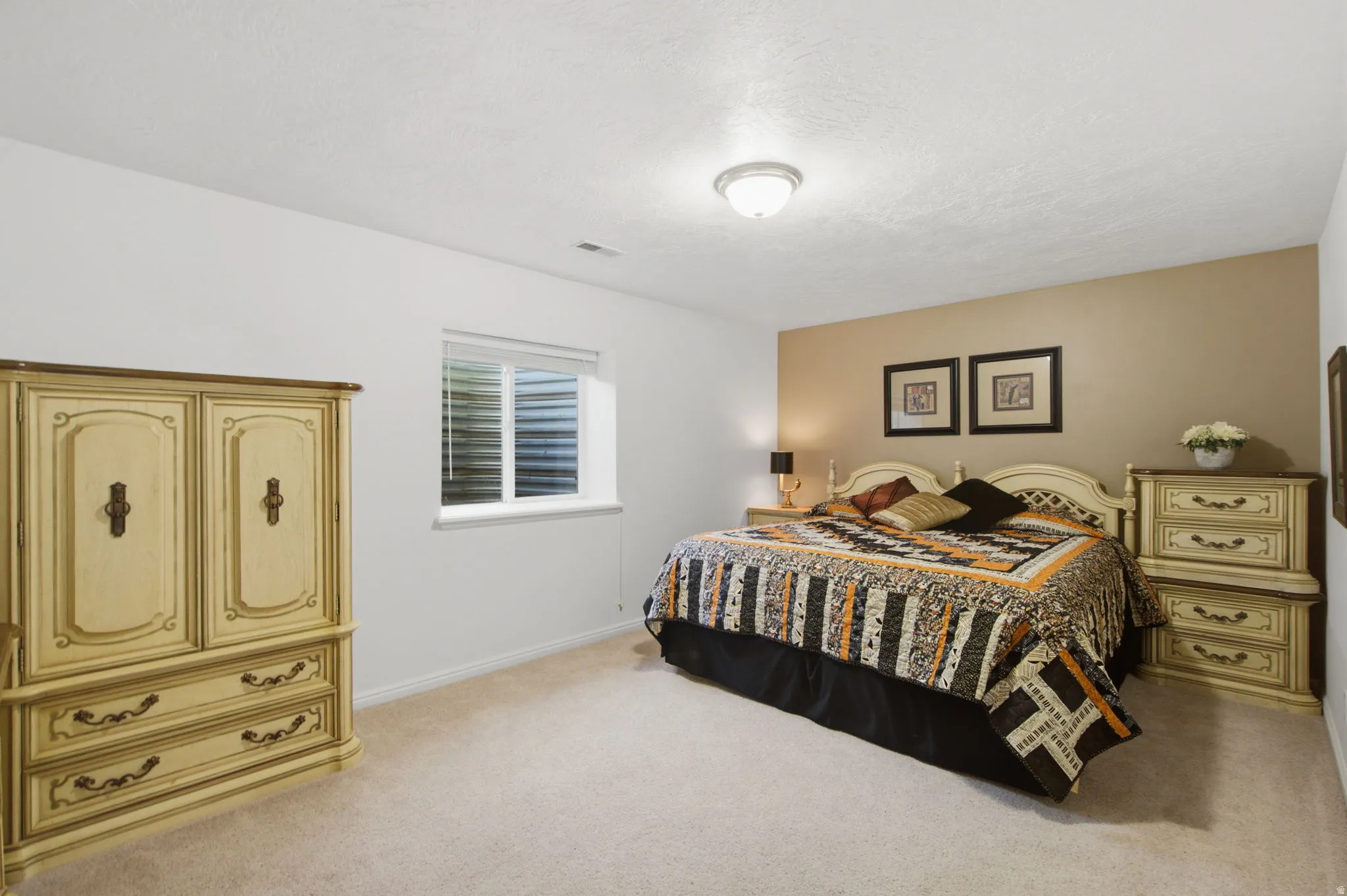 Carpeted room with a white ceiling and walls, featuring a single window with horizontal blinds