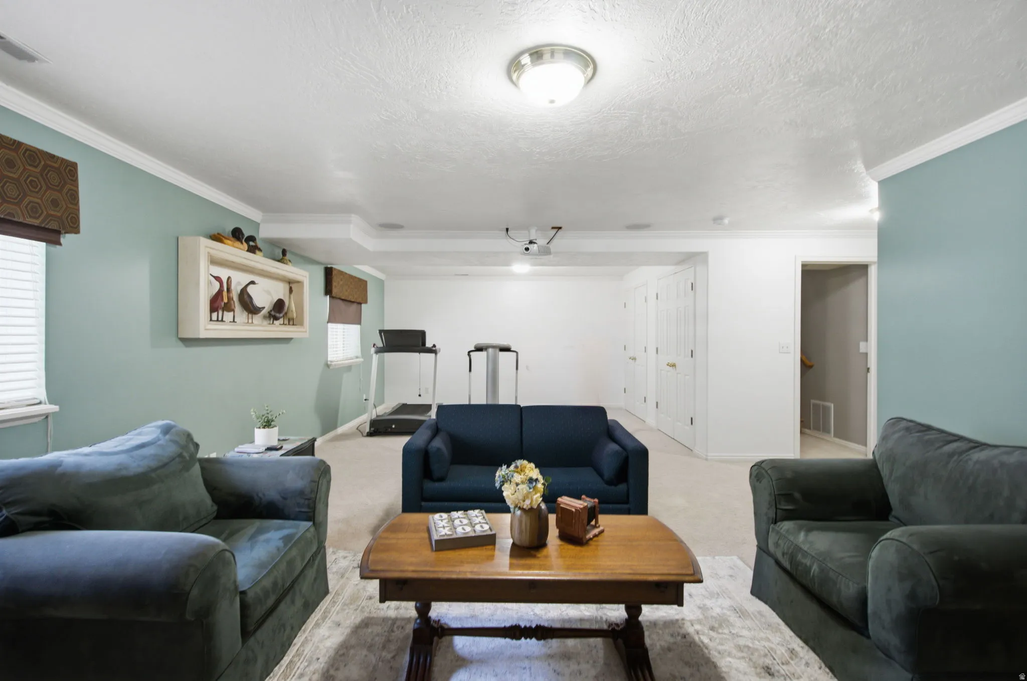 Spacious recreation area featuring light blue wall accents and white trim