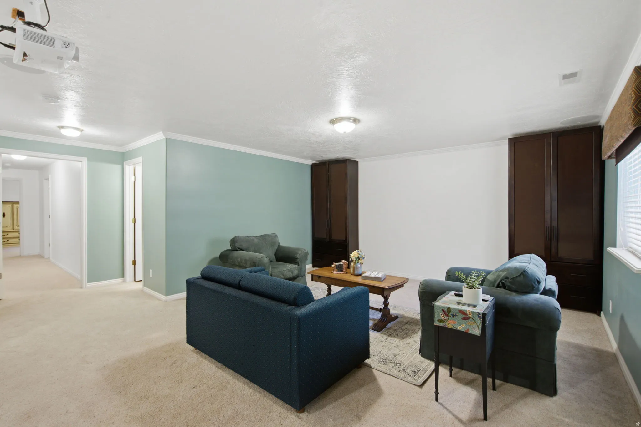 Spacious common area featuring light-colored carpeting and recessed ceiling lighting