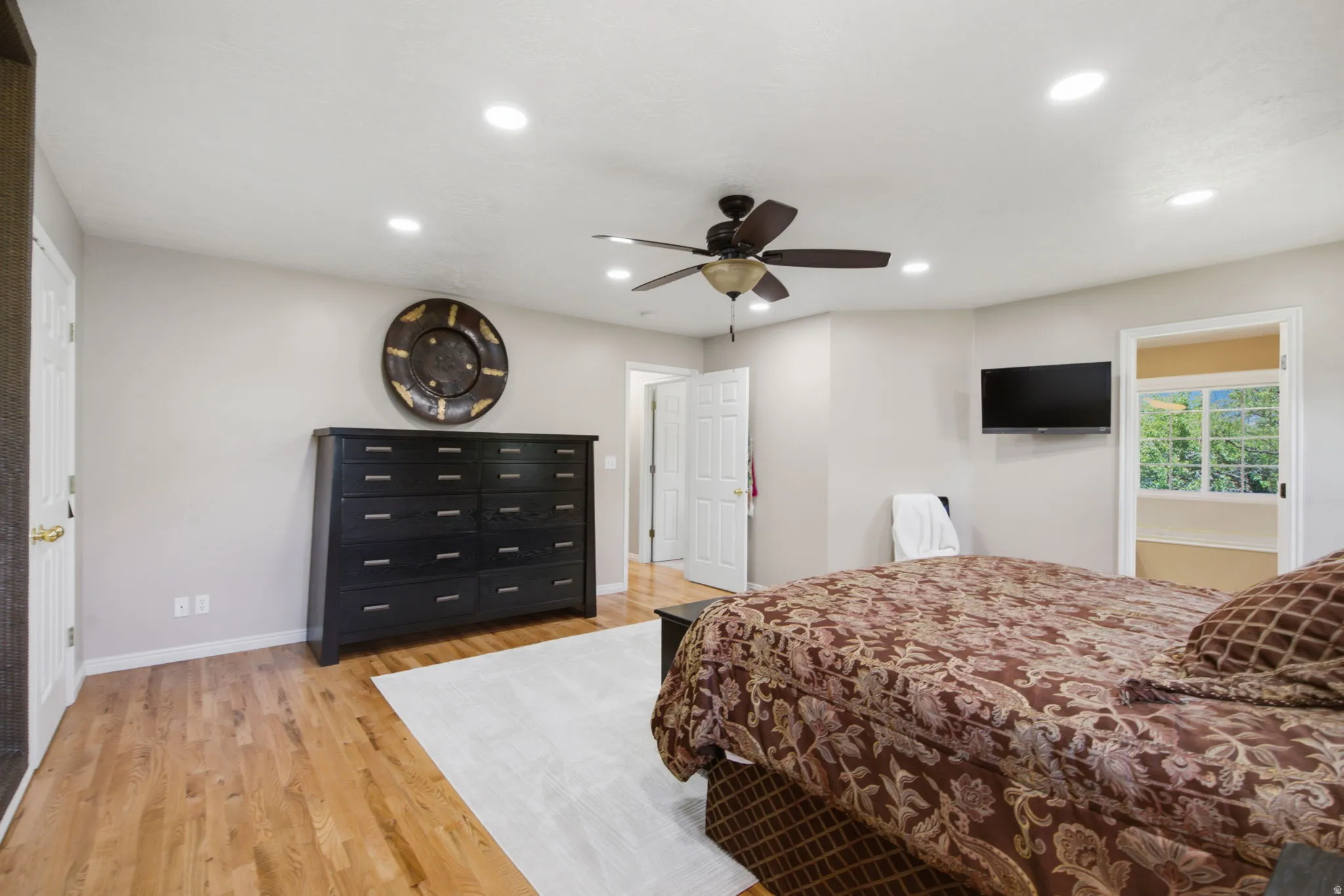 Bedroom featuring light wood-finish flooring, recessed lighting, and a ceiling fan