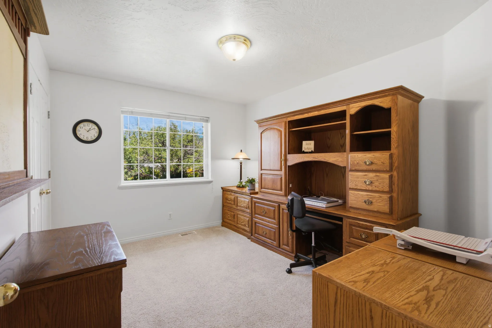 Room featuring light-colored carpet flooring and white painted walls