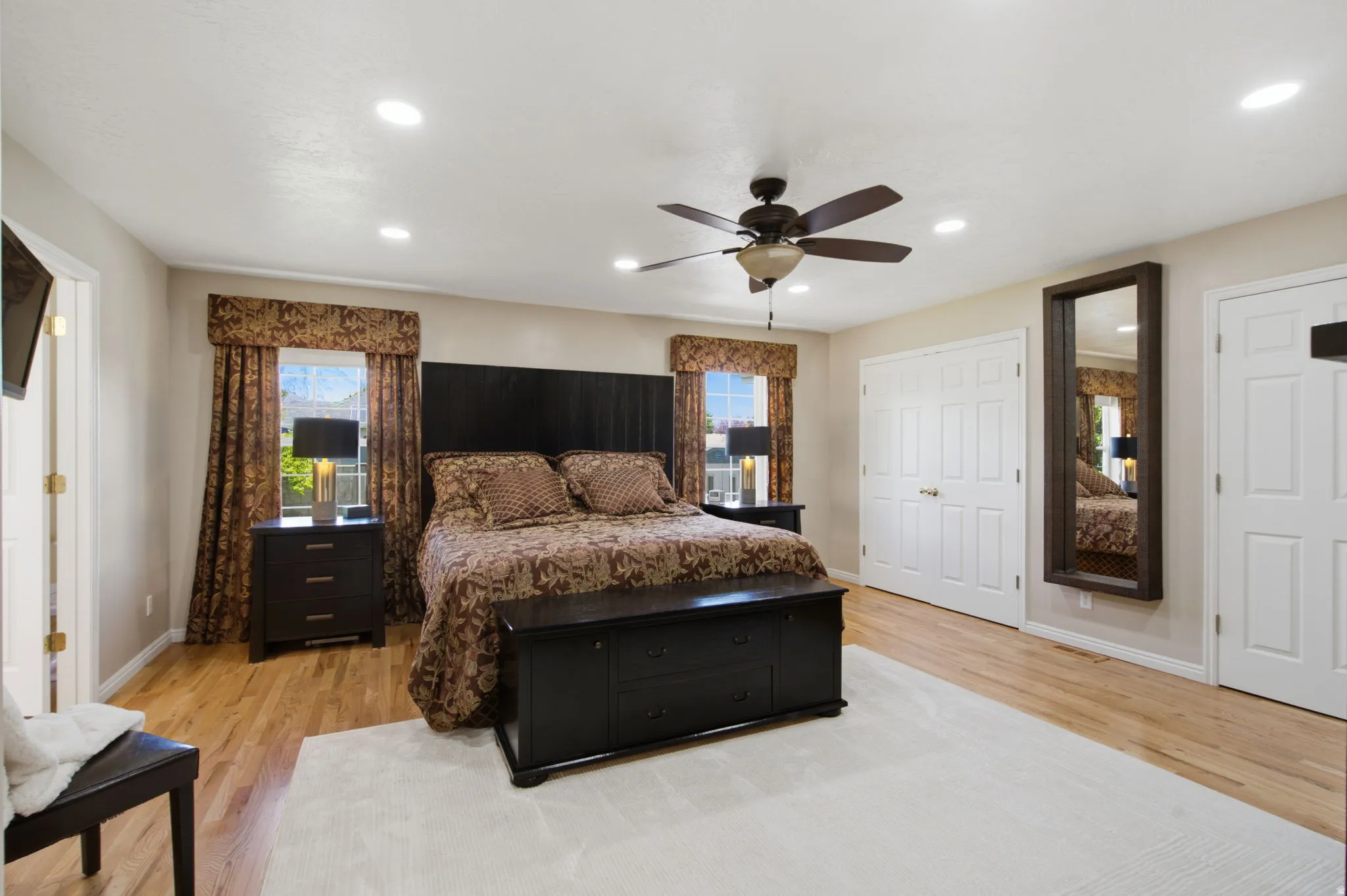 Spacious Master bedroom featuring wood-finish flooring, recessed lighting, and a ceiling fan