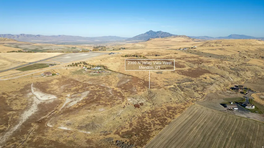 Expansive land parcel featuring varied topography and distant mountain ranges
