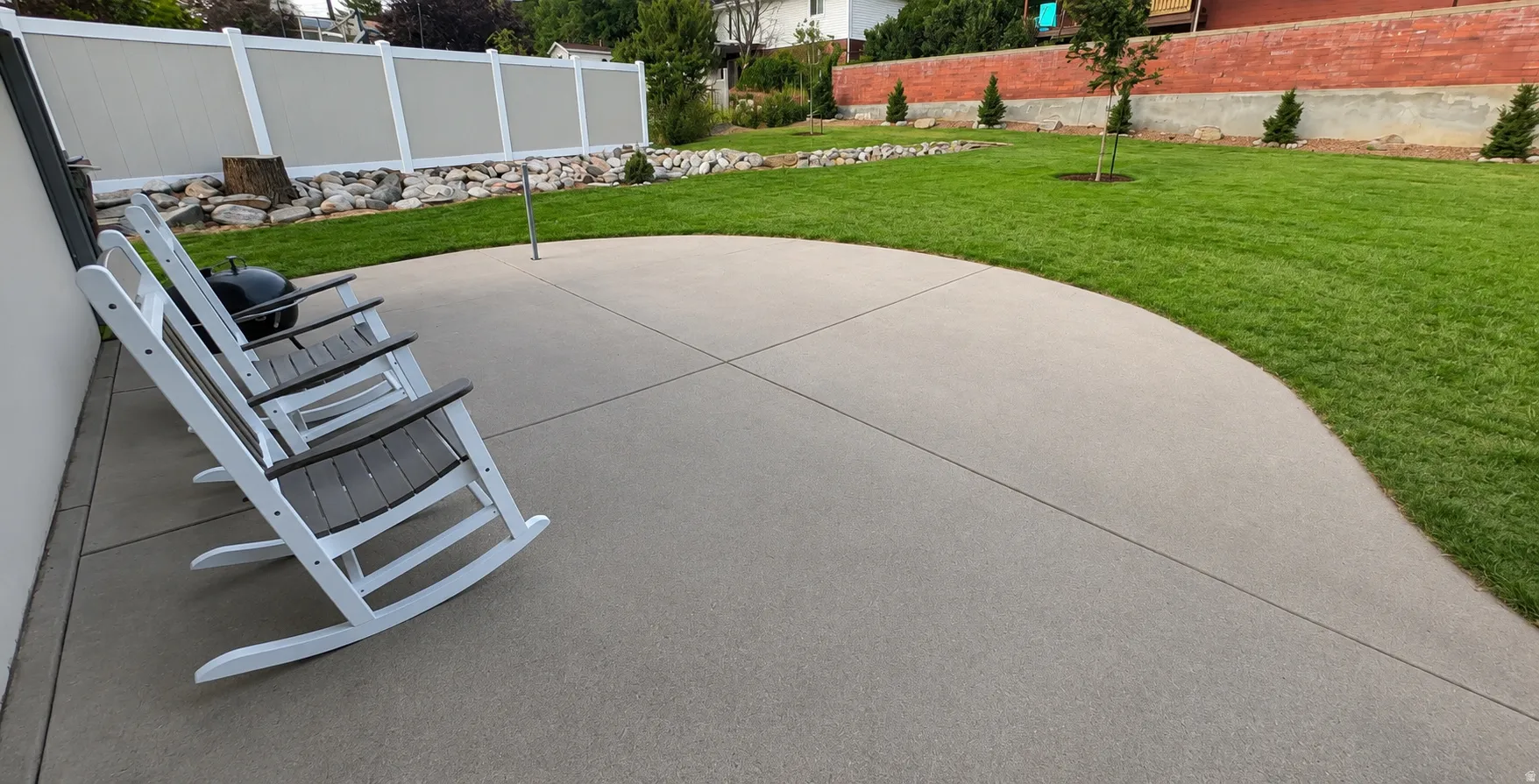Expansive outdoor patio with a curved edge and concrete surface