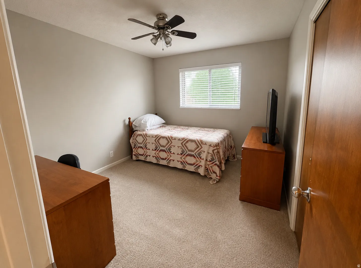 Room featuring light neutral wall paint, a window with white blinds, and a ceiling fan with multiple light fixtures