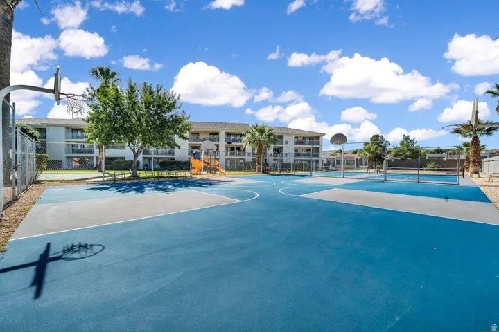 Outdoor multi-sport court featuring basketball hoops and volleyball nets