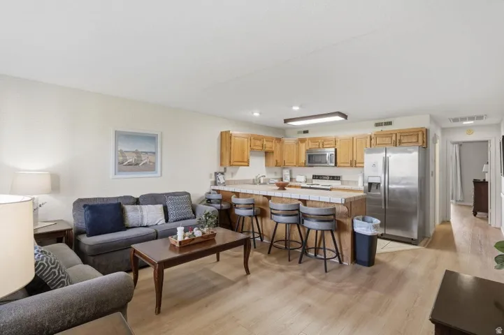 Open-concept living area featuring wood-finish flooring throughout