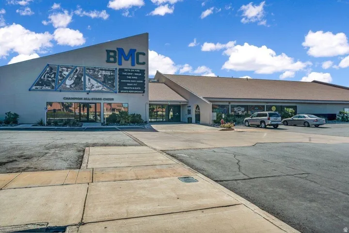 Commercial building featuring a prominent angled facade with large window displays