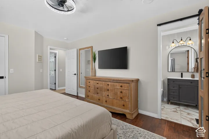 Wood-finish flooring throughout, complemented by a contemporary ceiling fan with integrated lighting