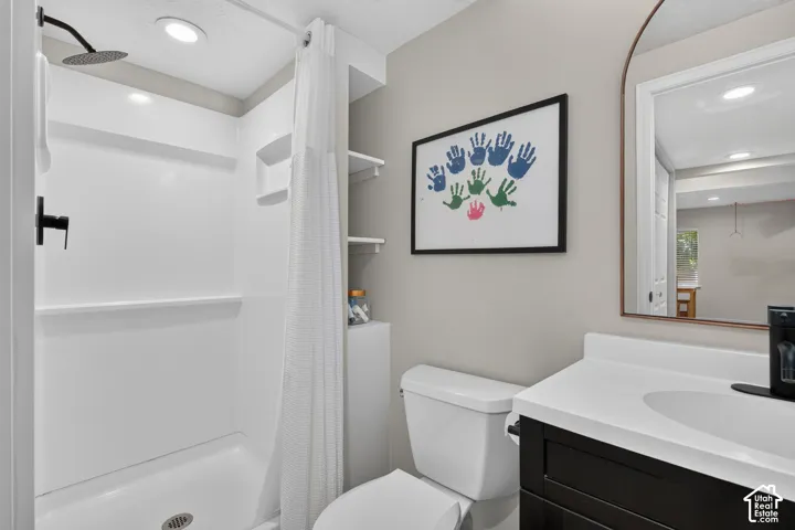 Bathroom featuring a white shower stall with matte black fixtures and an overhead light