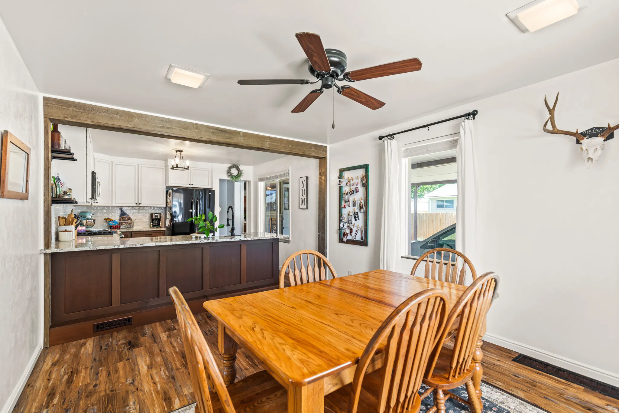 Kitchen with a breakfast bar featuring dark wood-finish cabinetry and a light-toned countertop