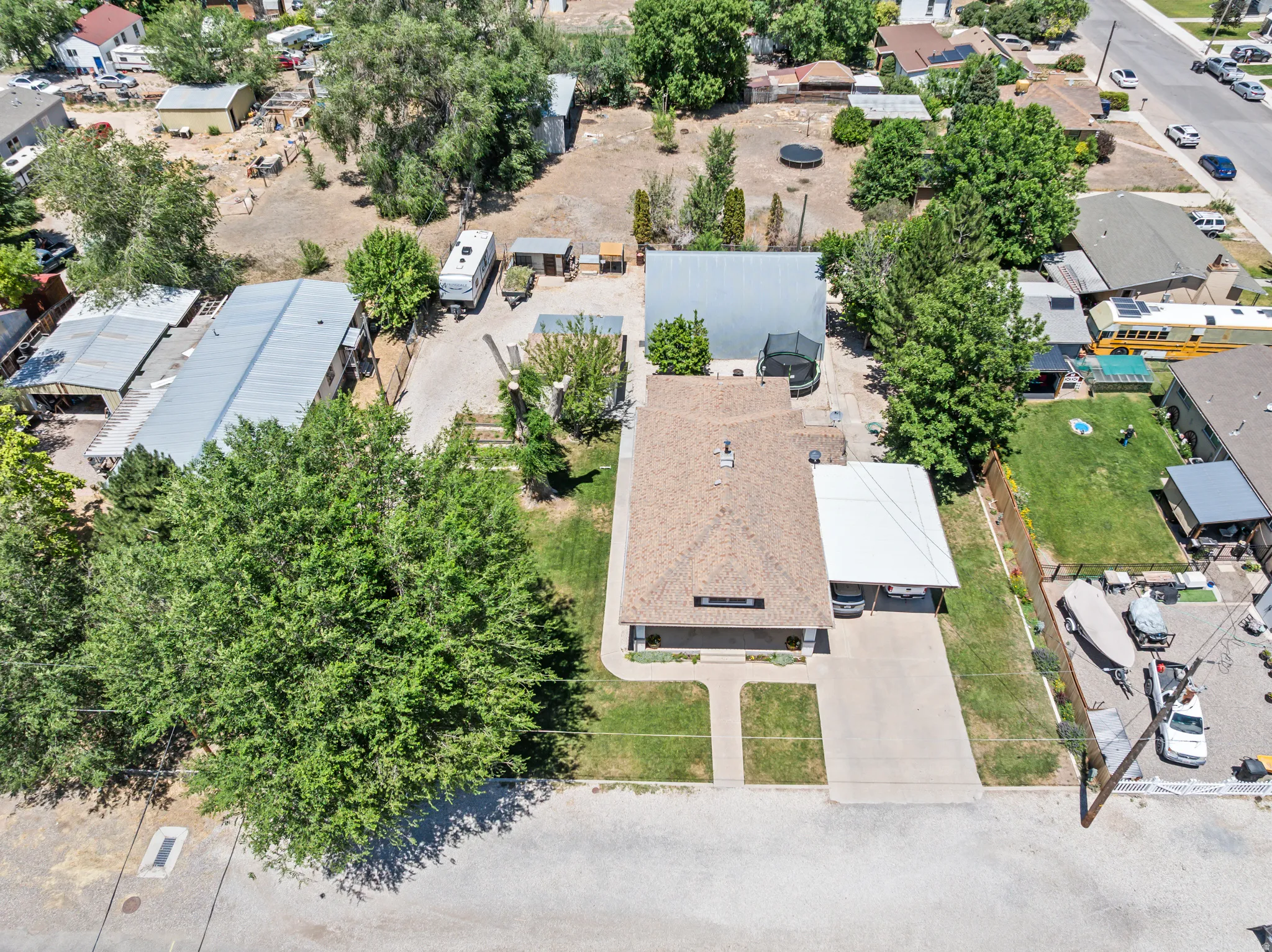 Single-story residence featuring a shingle roof and an attached carport