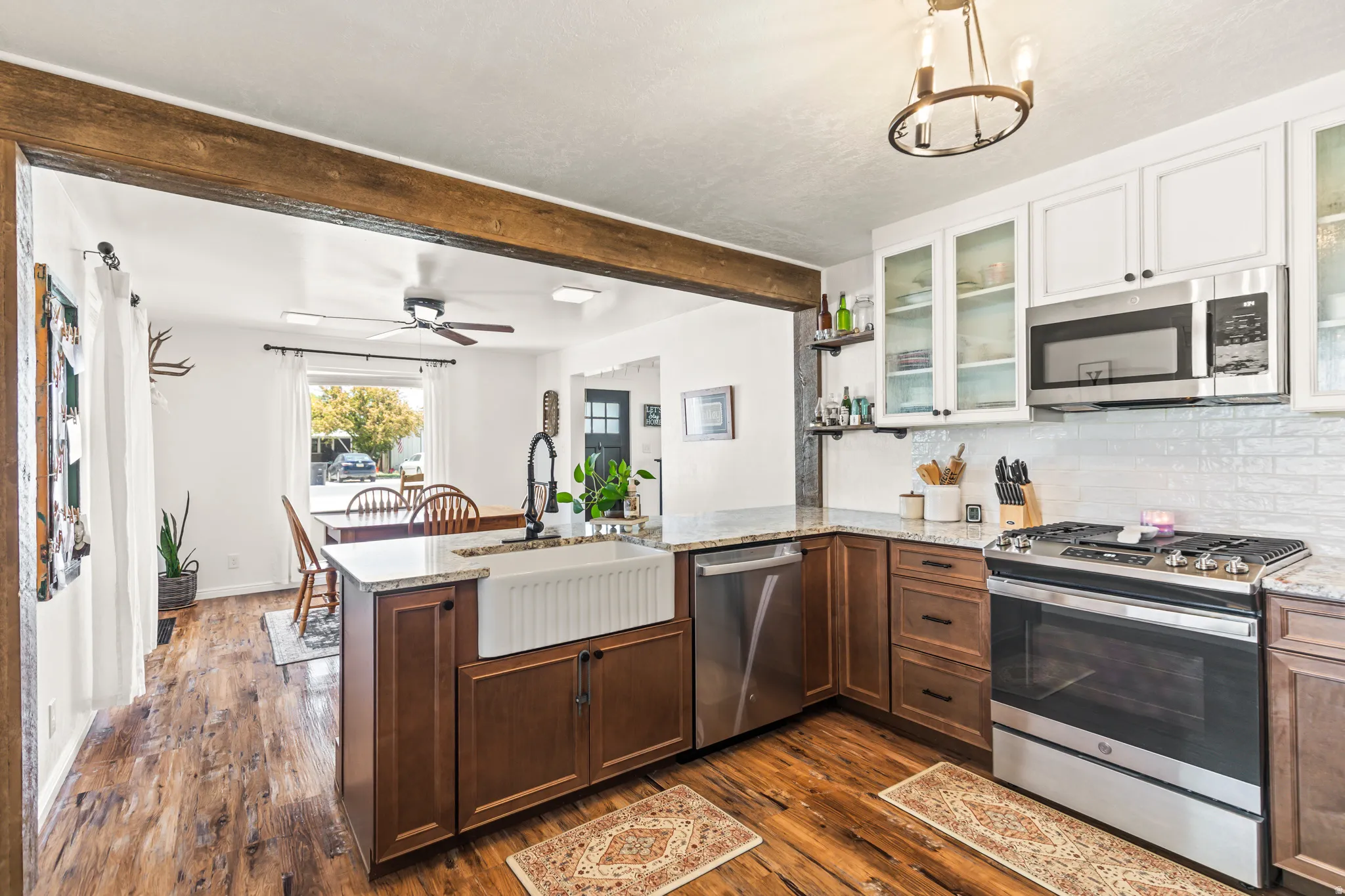 Kitchen featuring an apron-front sink, granite countertops, and stainless steel appliances