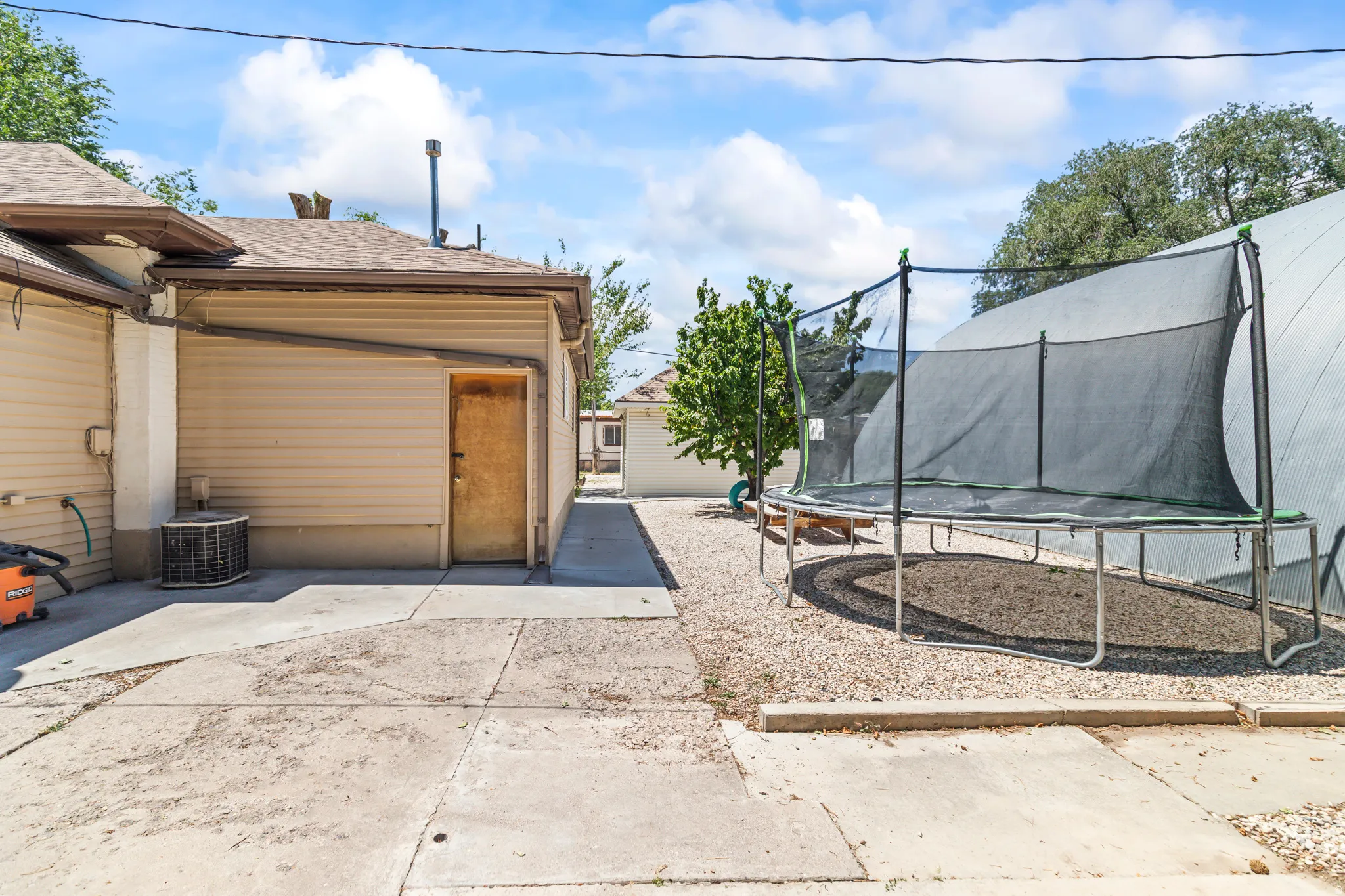 Concrete patio area bordered by gravel landscaping
