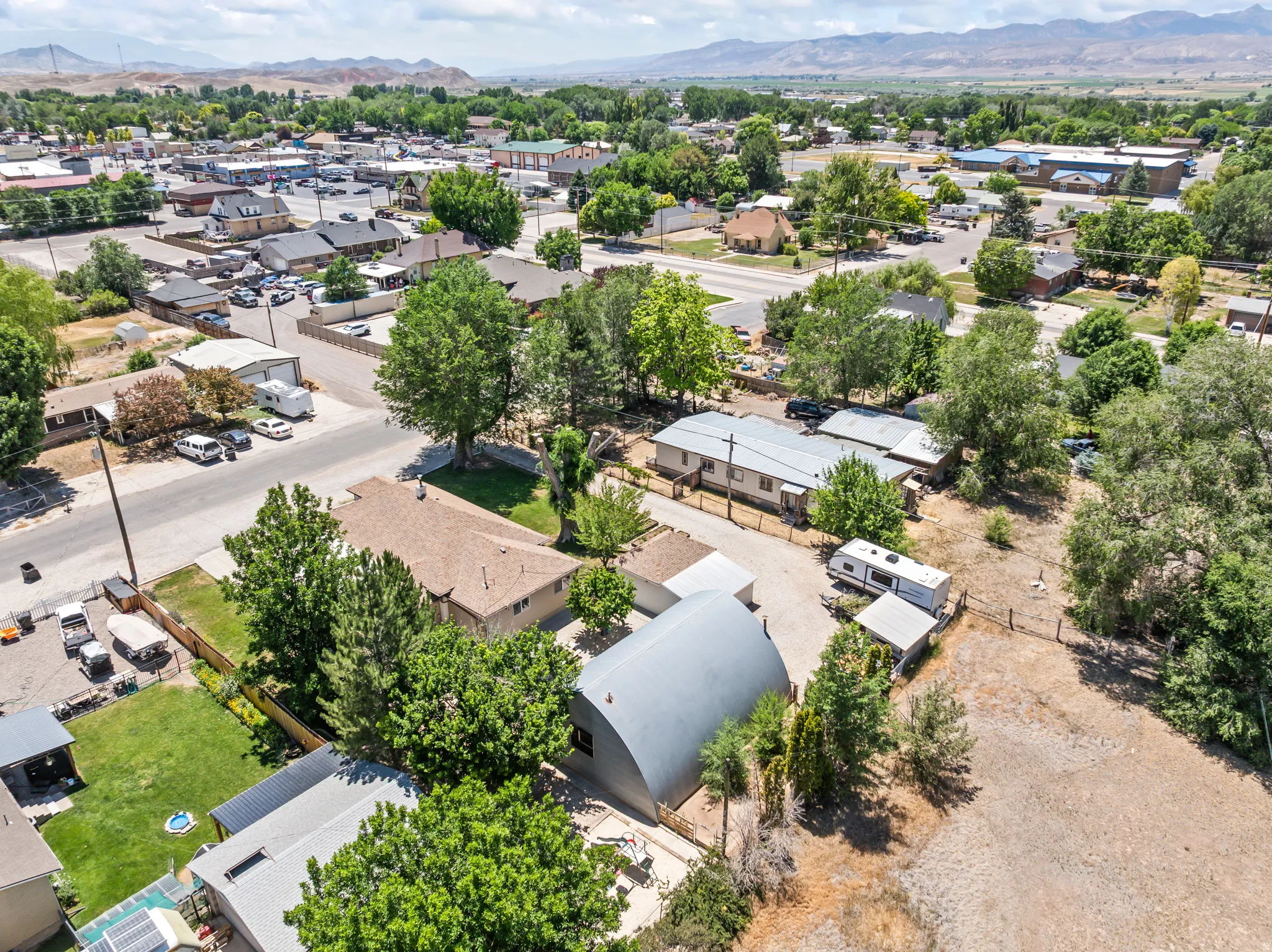 Aerial perspective showcasing a residential neighborhood with a variety of housing styles and established trees