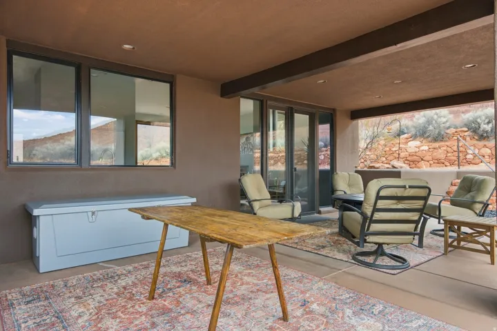 Covered patio with recessed lighting, concrete flooring, and sliding glass doors