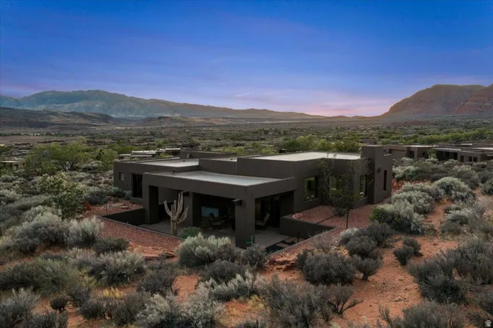 Modern desert dwelling featuring flat roofs and a dark exterior finish