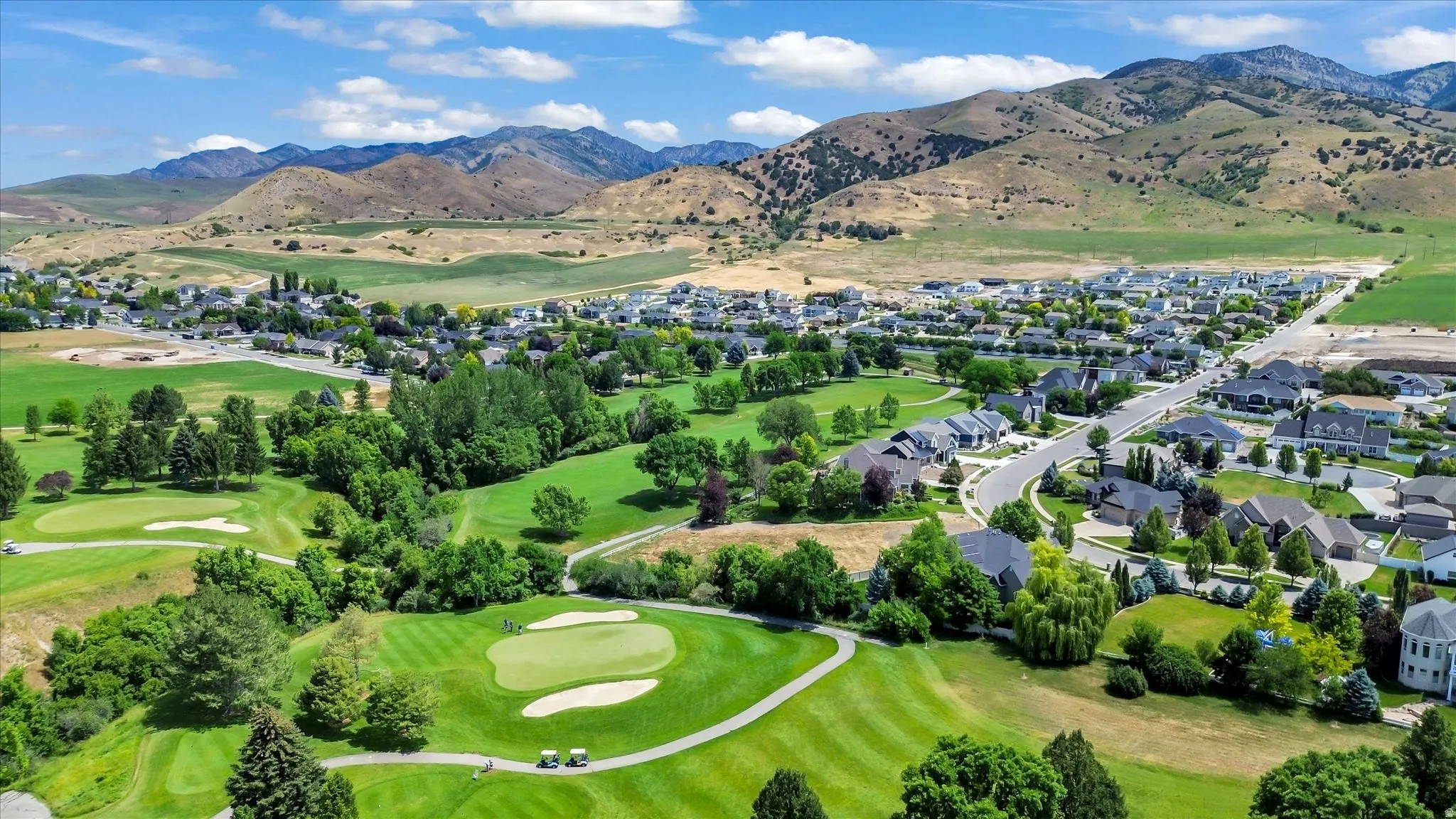 Expansive golf course landscape with manicured greens and sand traps