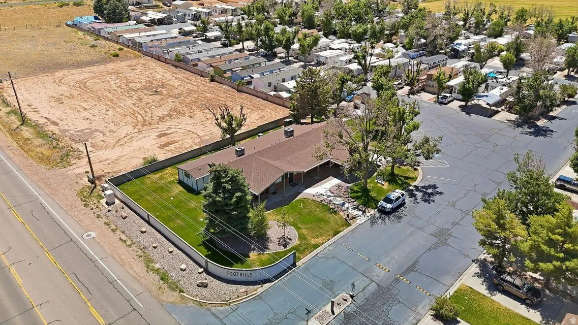 Spacious property featuring a large land parcel, established landscaping, and a perimeter fence