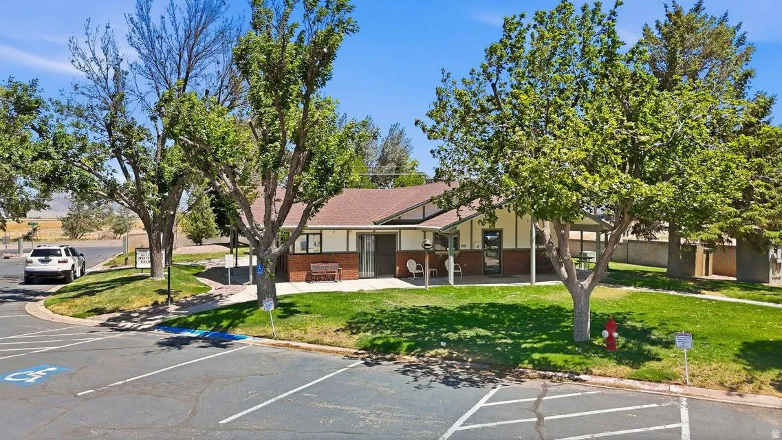 Community building with an inviting covered patio and a red shingle roof