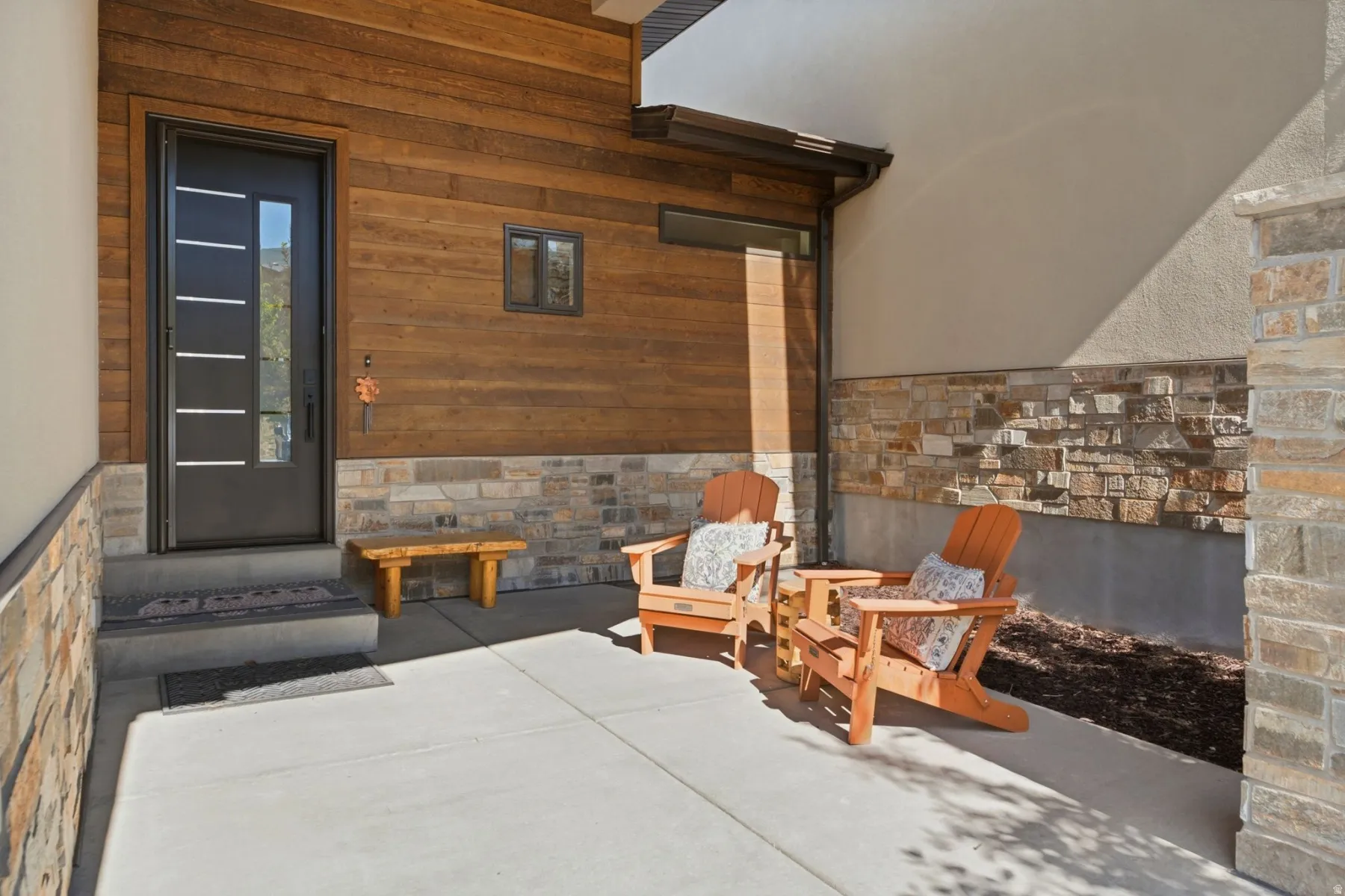 Contemporary entry featuring a dark-framed glass paneled door