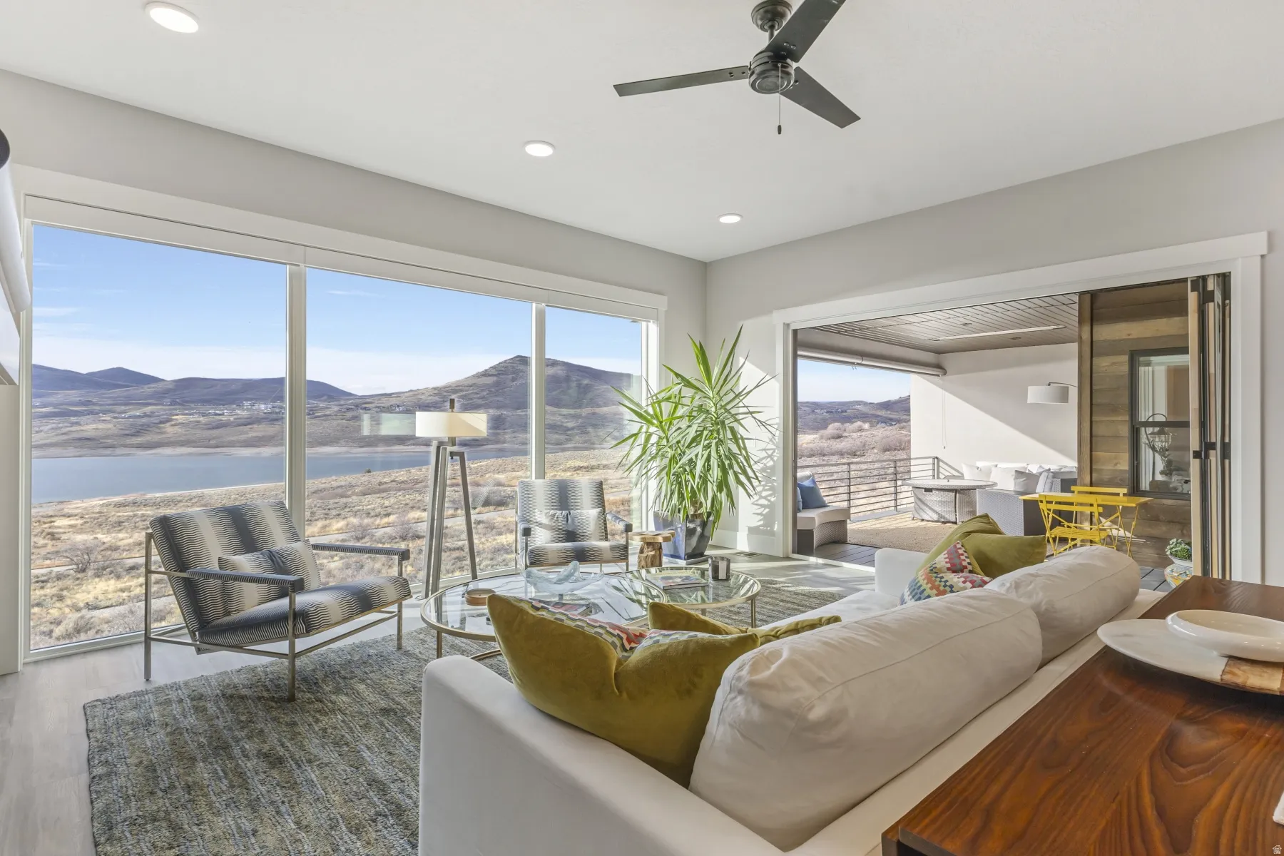 Floor-to-ceiling windows with expansive lake and mountain scenery