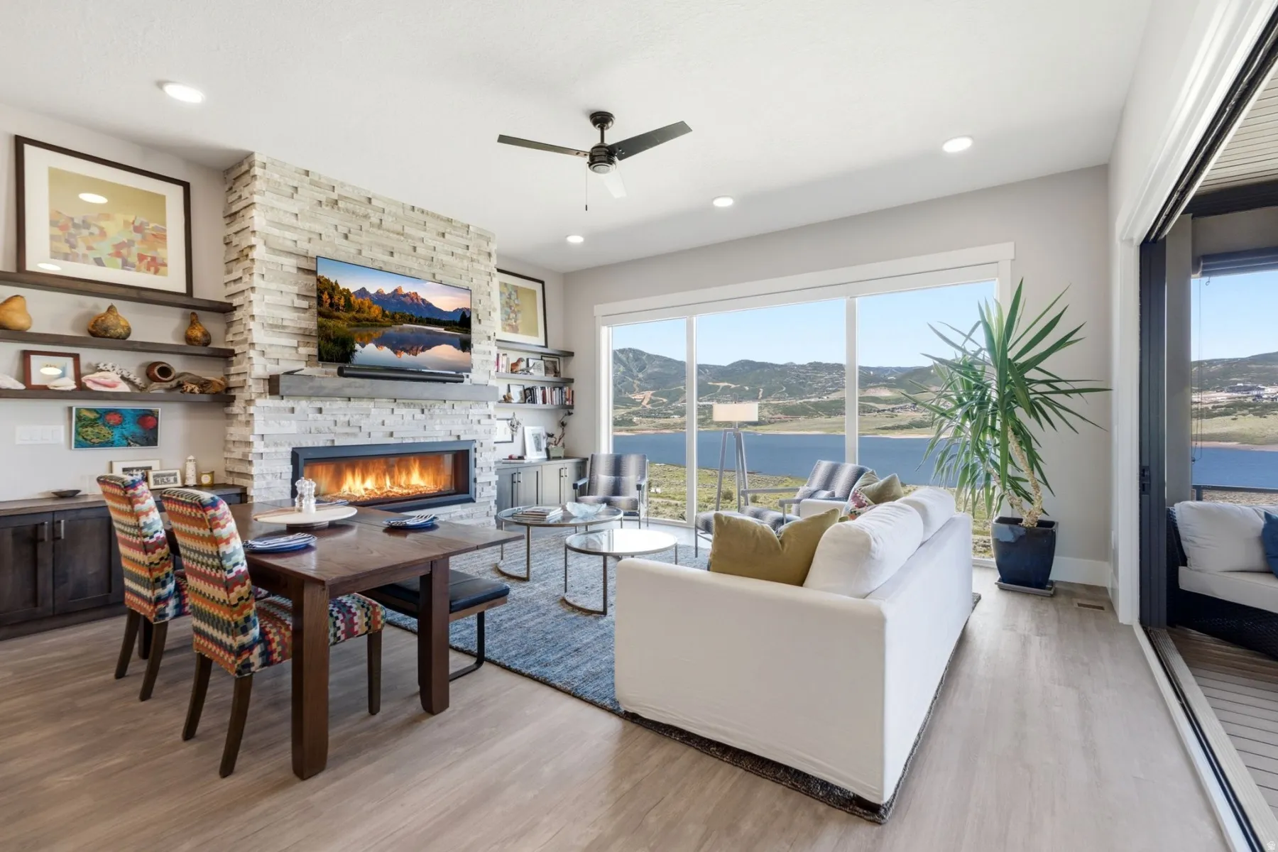 Expansive living area with panoramic water and mountain scenery