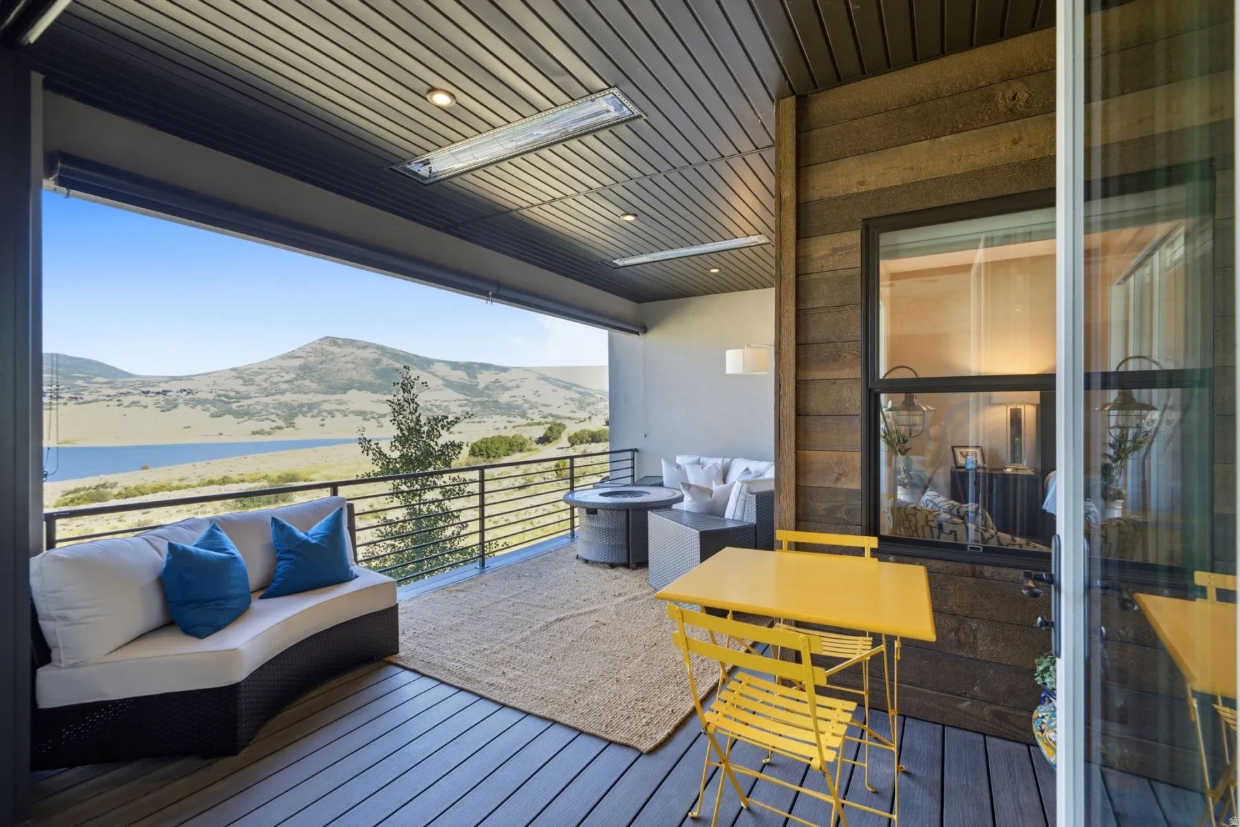 Expansive outdoor living area featuring a durable composite deck, horizontal railing, and built-in ceiling heaters