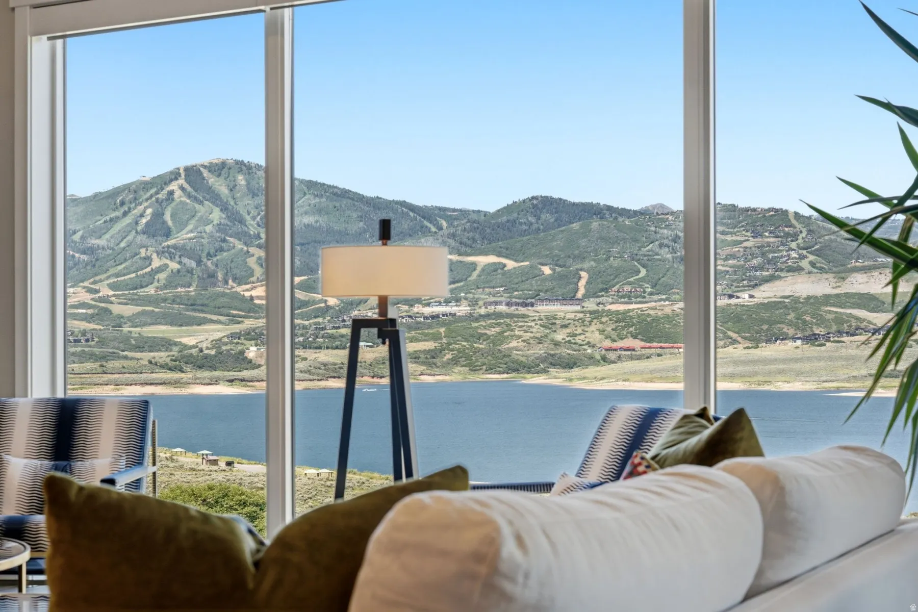 Expansive windows framing mountain and lake scenery