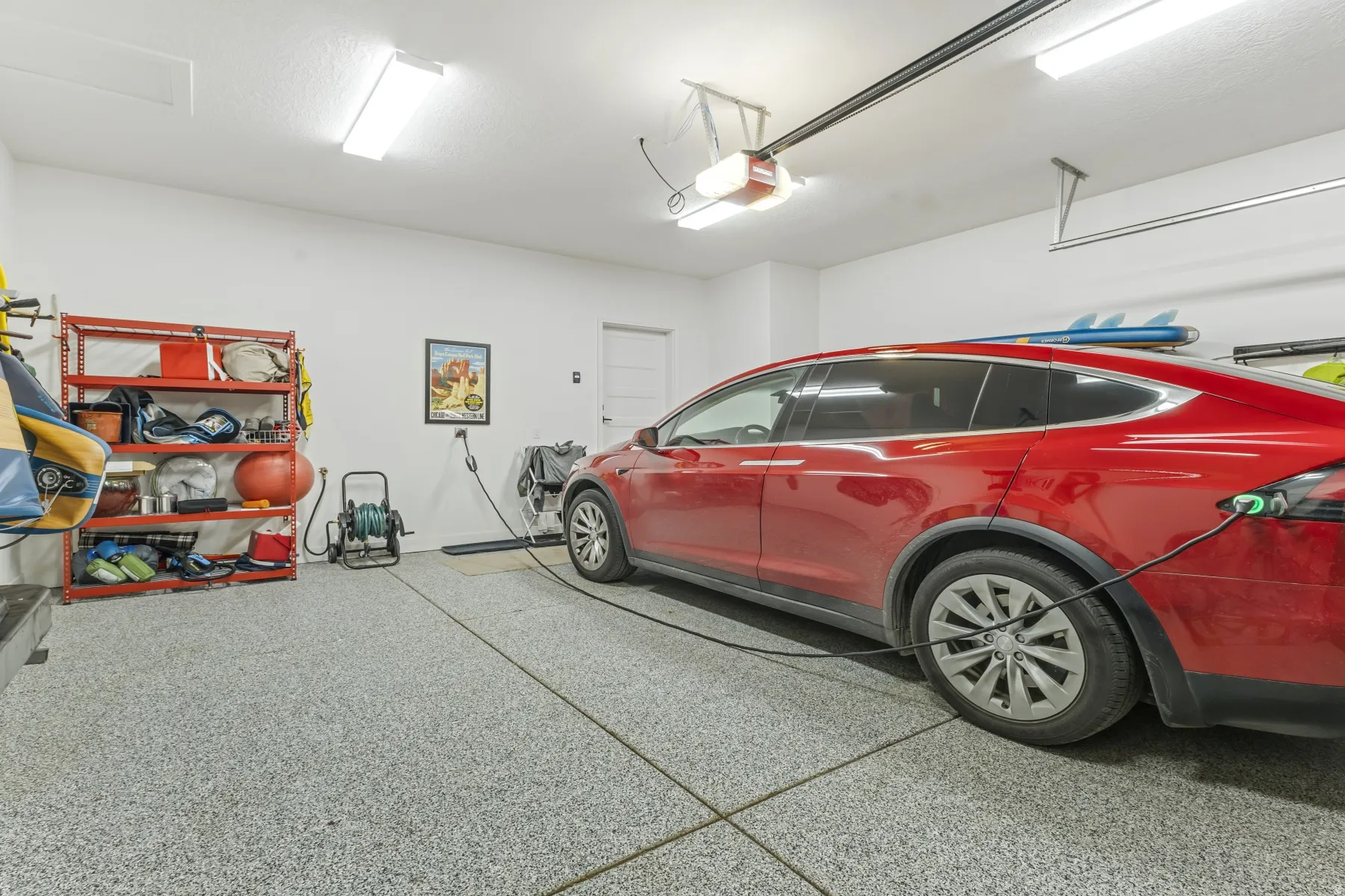 Garage featuring an epoxy flake flooring system and white painted walls