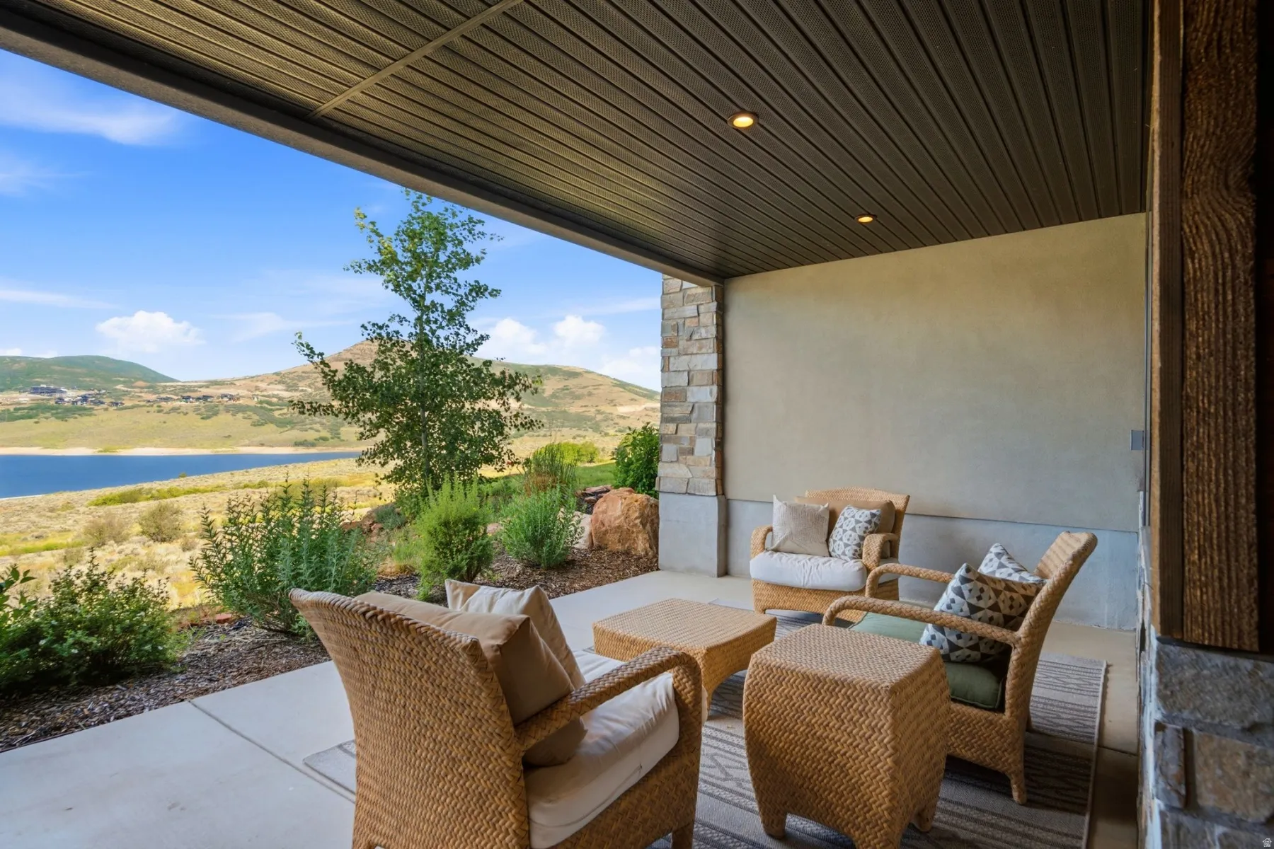 Covered patio featuring a slatted ceiling with recessed lighting