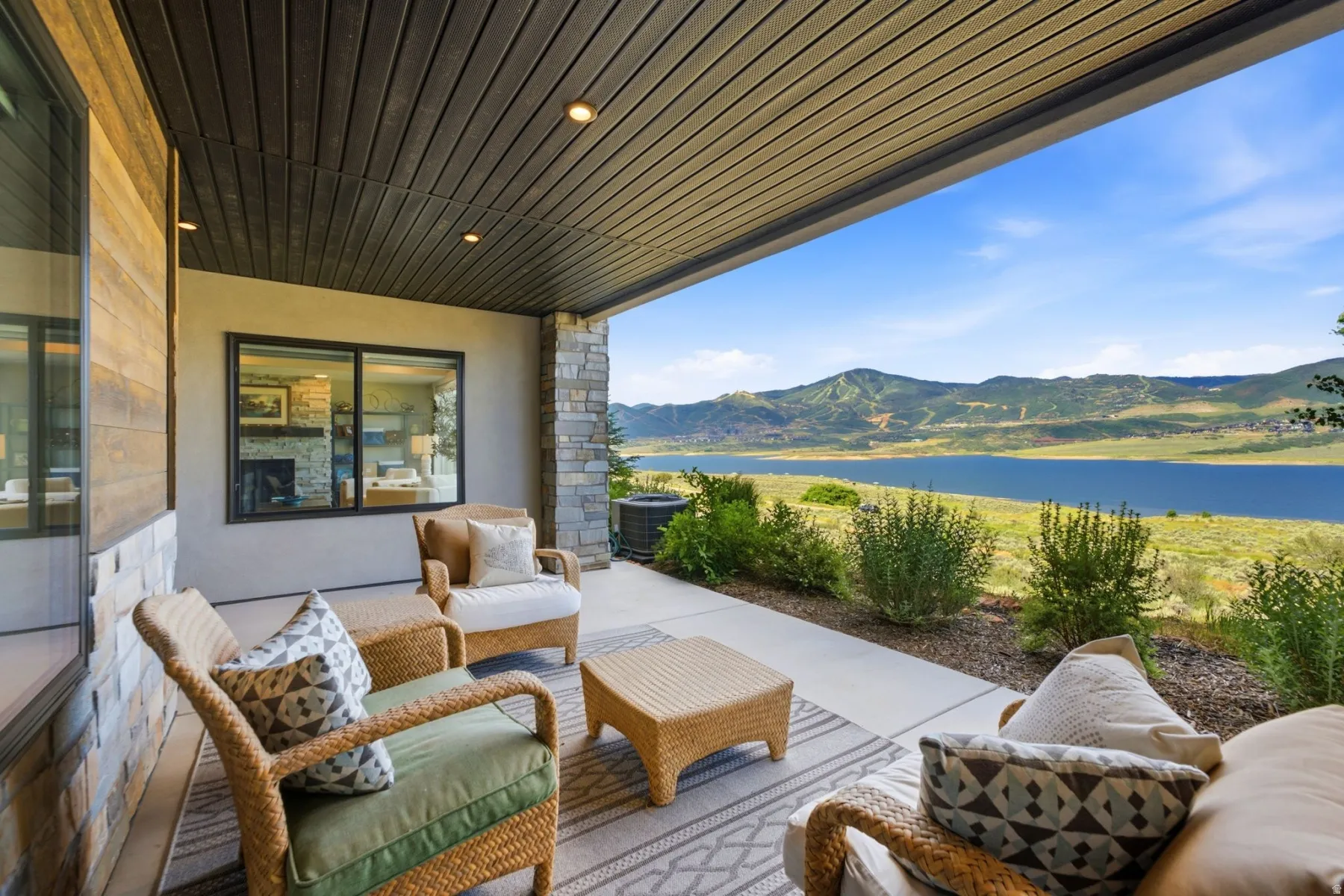 Covered patio featuring recessed lighting and a stone accent wall