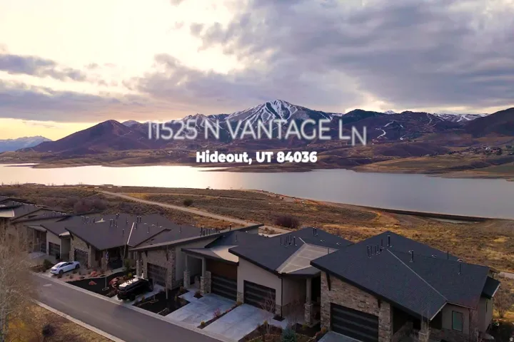 Modern residences with stone and stucco exteriors, dark shingled roofs, and attached garages