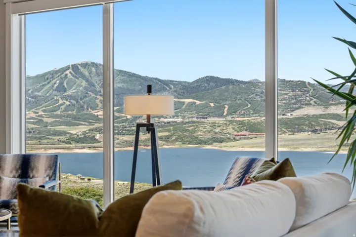 Expansive windows framing mountain and lake scenery