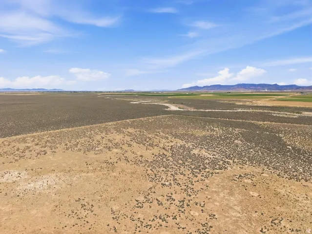 Expansive undeveloped land featuring varied terrain and distant mountain ranges