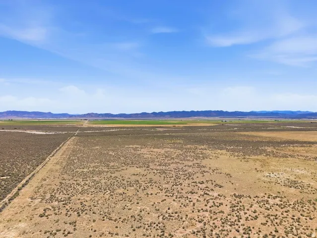 Expansive undeveloped land featuring a combination of natural vegetation and agricultural fields