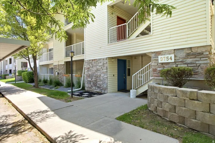 Multi-level building with horizontal siding and stone veneer accents