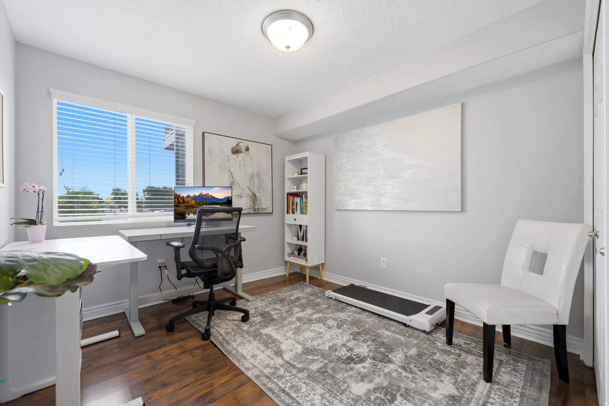 Bright interior space with wood-finish flooring and light gray walls