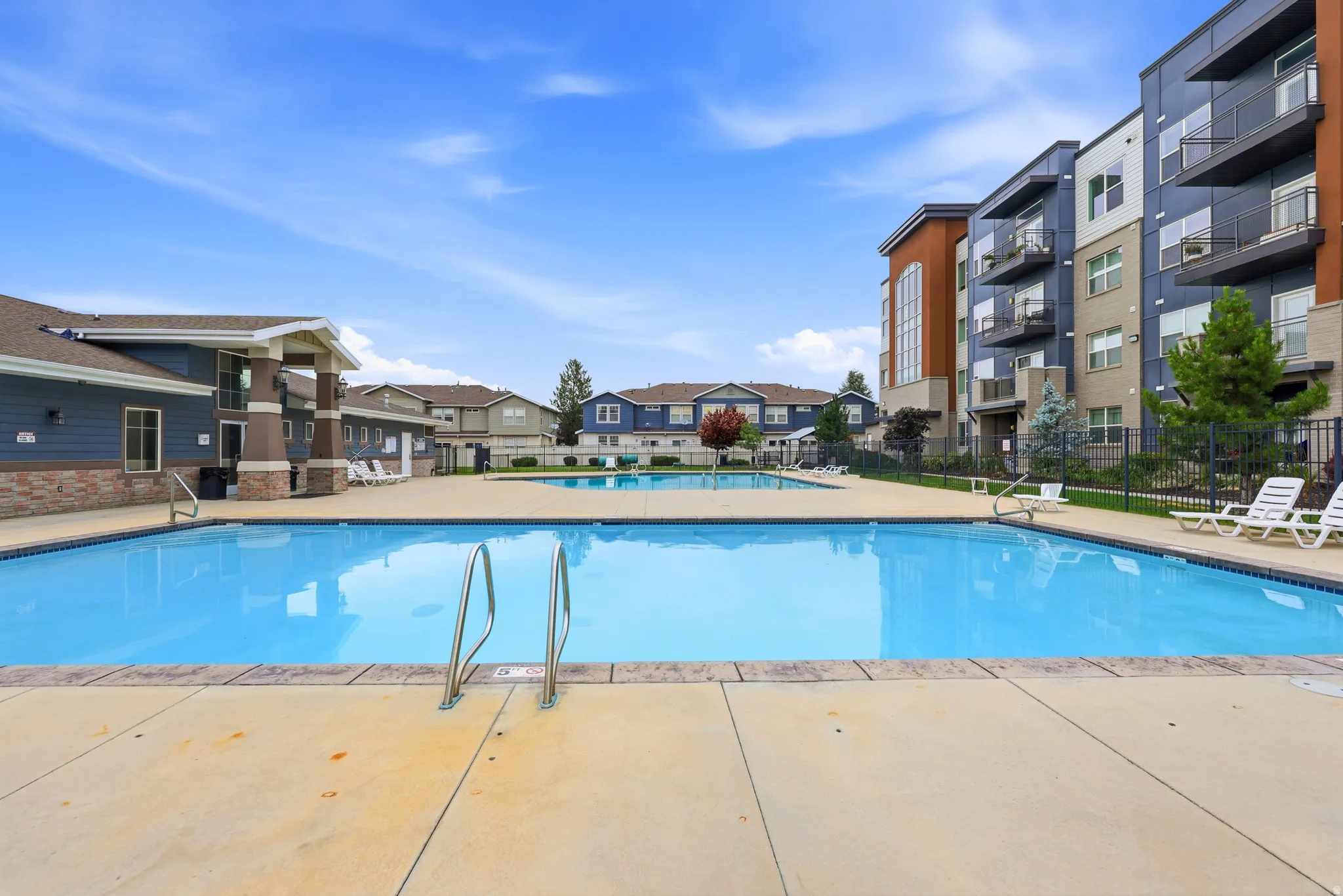 Community swimming pool with concrete decking