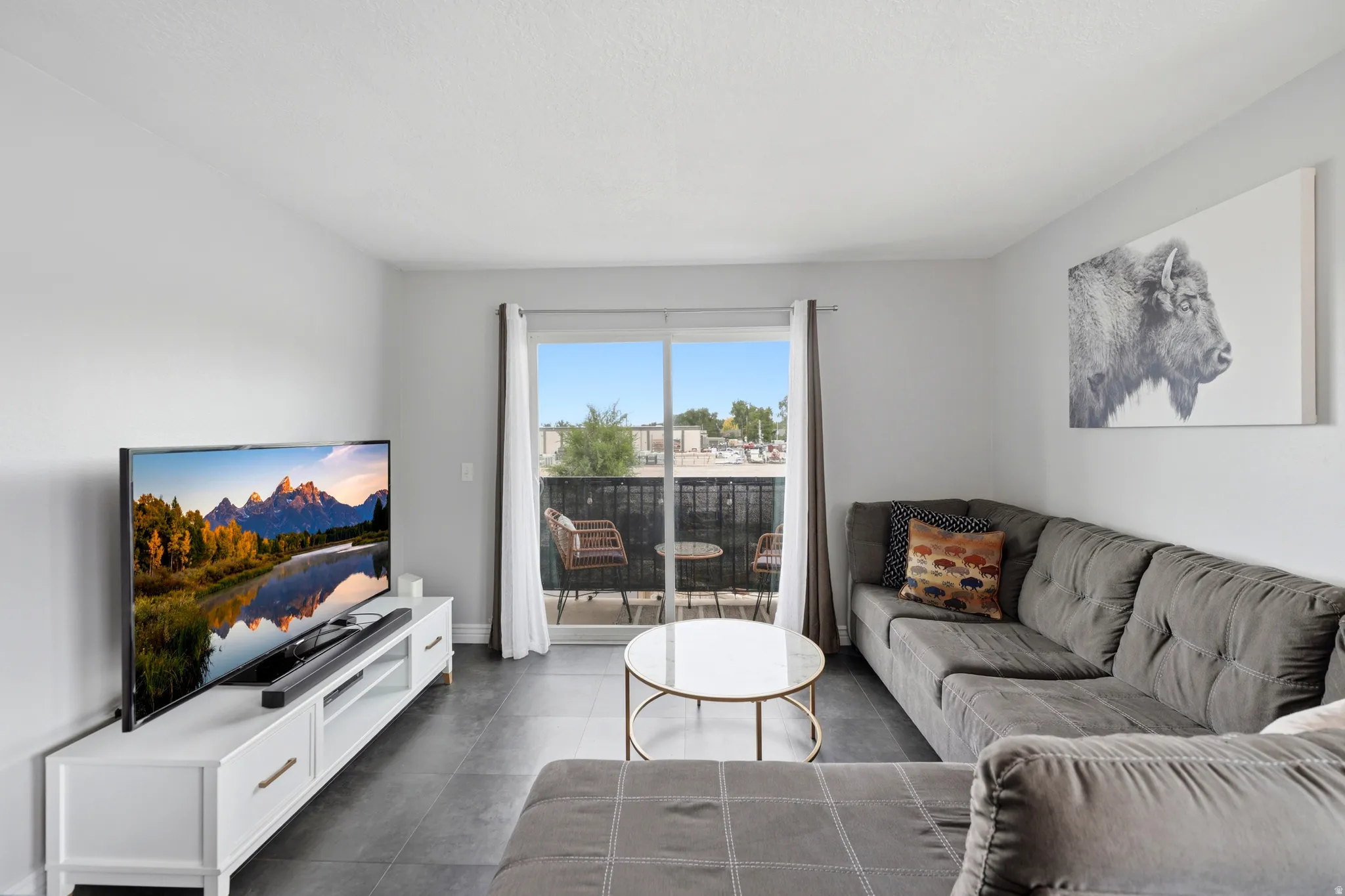 Living area featuring dark tile flooring and white painted walls